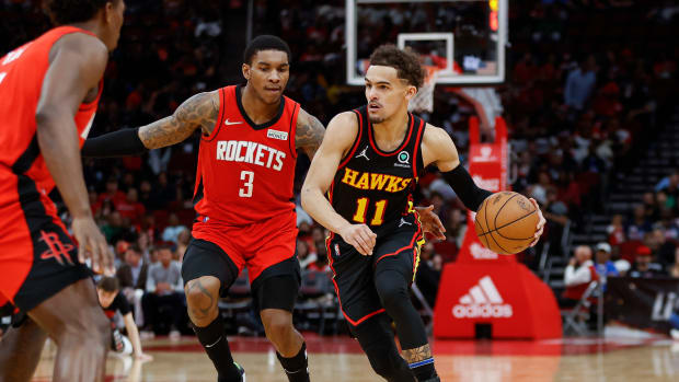 Apr 10, 2022; Houston, Texas, USA; Atlanta Hawks guard Trae Young (11) dribbles the ball as Houston Rockets guard Kevin Porter Jr. (3) defends during the third quarter at Toyota Center.